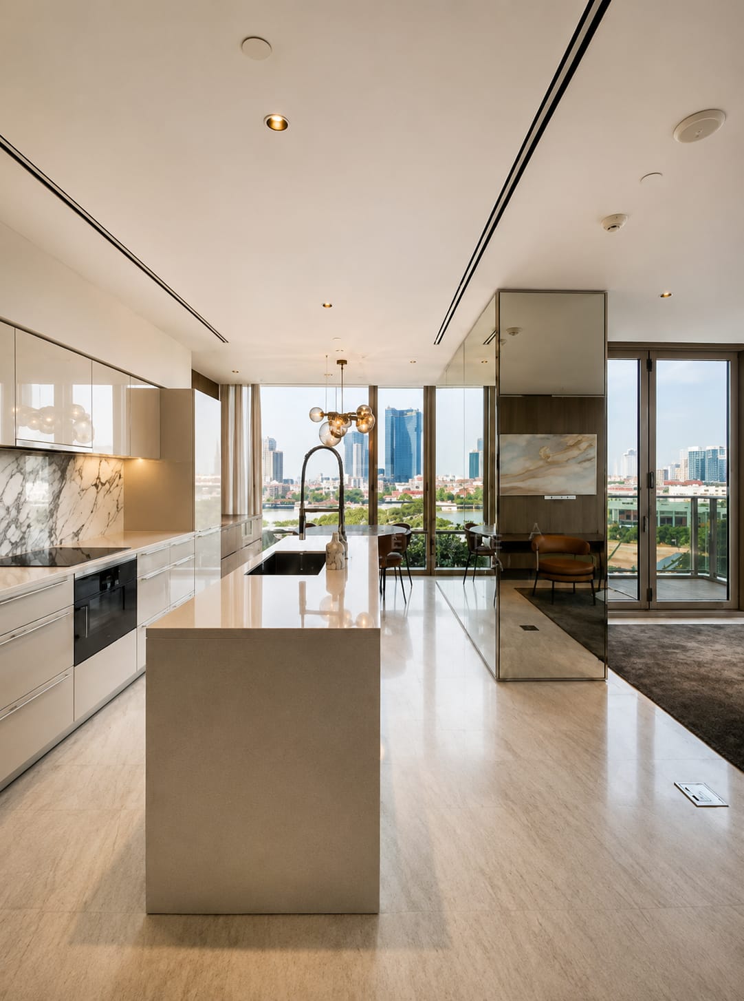 The kitchen of the 120 square metre residence at Four Seasons Private Residences, a stone island on travertine with the dining table and balcony beyond