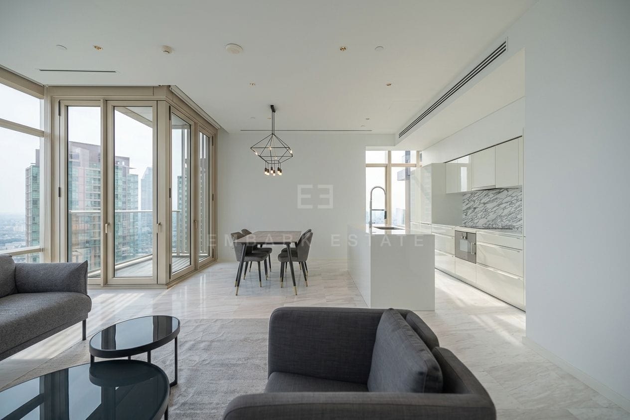 Four Seasons Private Residences Bangkok — dining area and white kitchen with folding glass doors to the balcony
