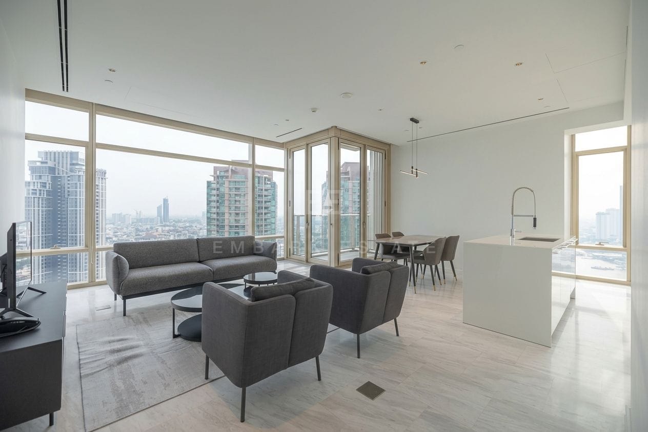 Four Seasons Private Residences Bangkok — living room sofas and kitchen island beneath the city windows