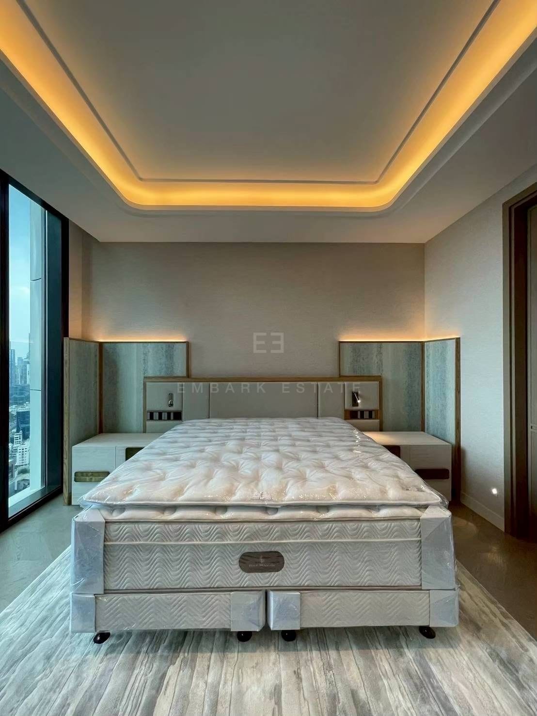 A bedroom at ONE89 Wireless, a timber-panelled headboard wall with a backlit shelf and glazing onto the city