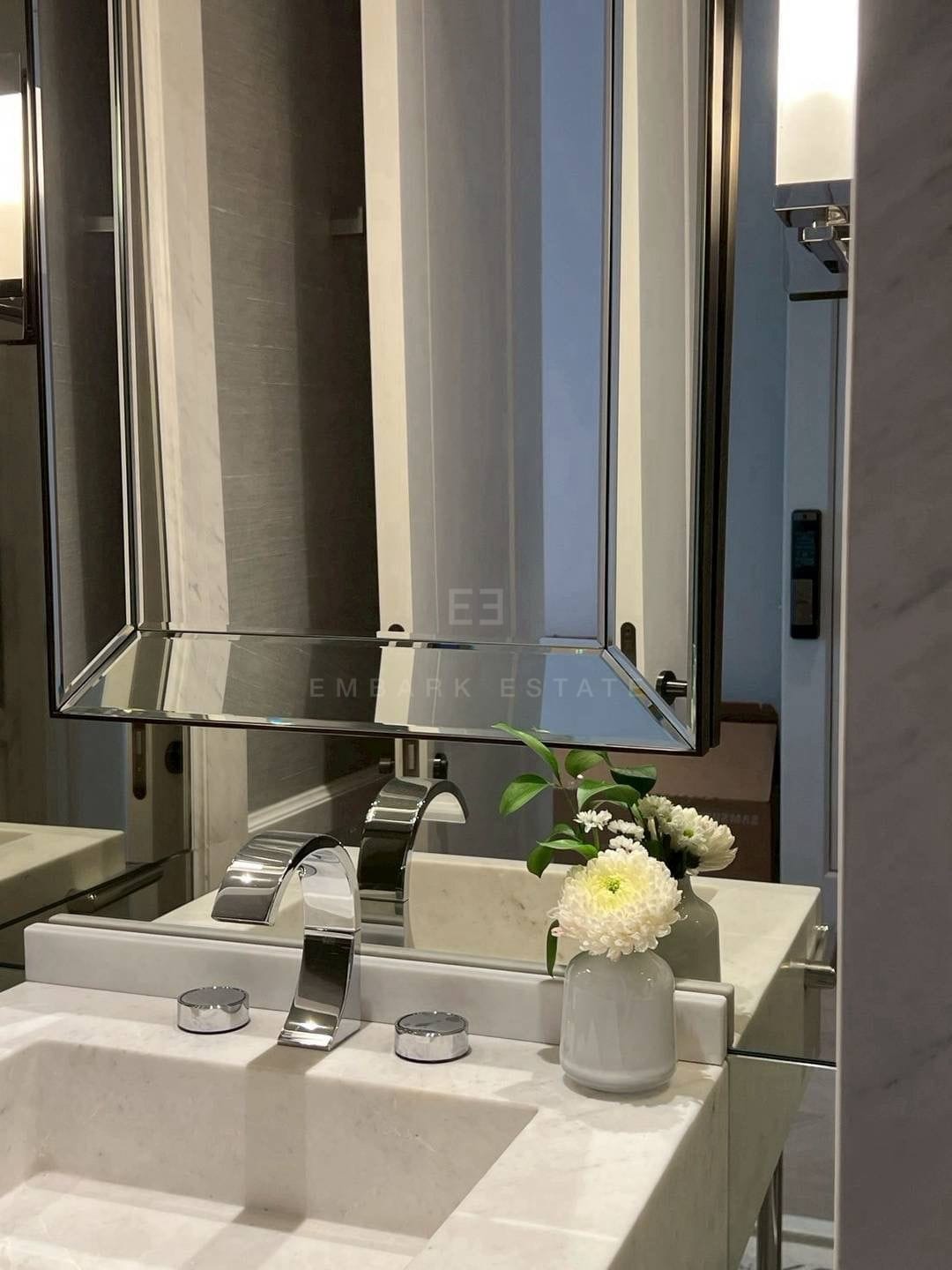The bathroom vanity at ONE89 Wireless, a stone basin and chrome mixer beneath a tall mirror