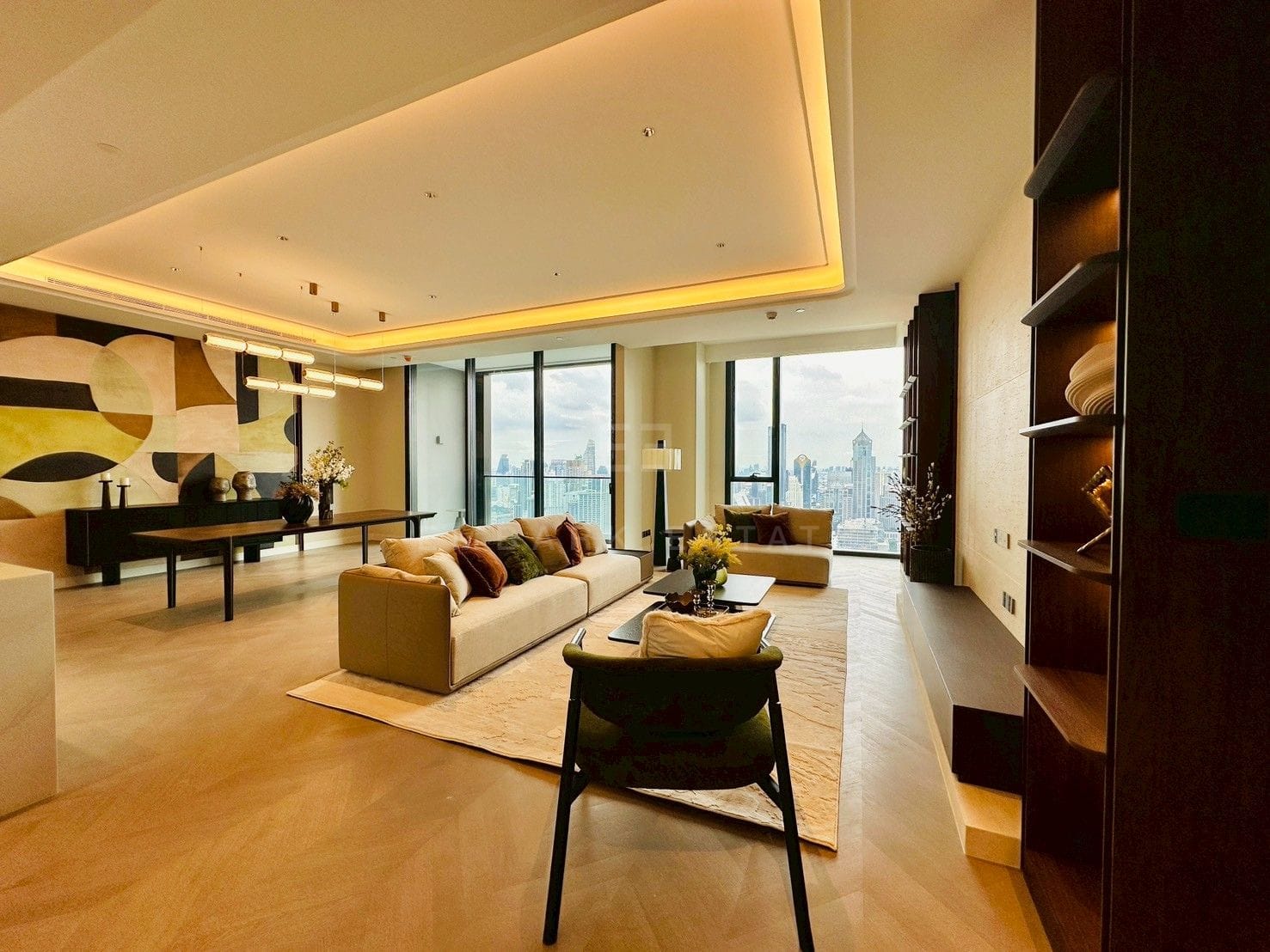 Living and dining rooms at ONE89 Wireless, Bangkok, seen from the hall, with two walls of glazing over the Bangkok skyline