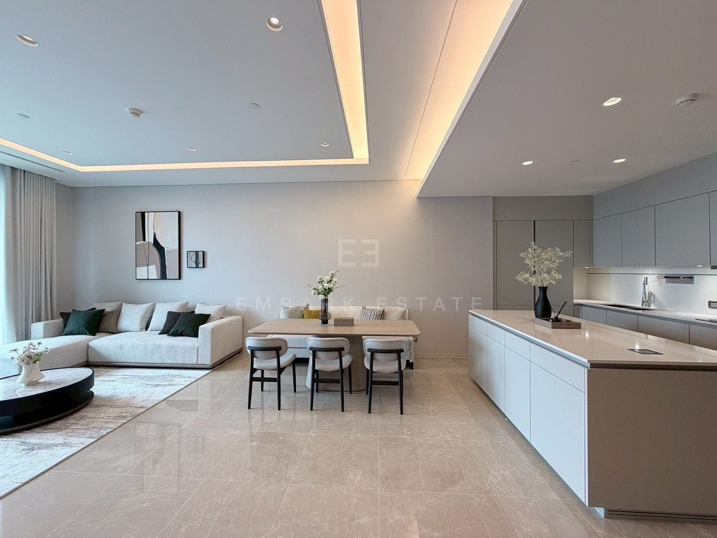 The living room, dining table and kitchen island at Sindhorn Kempinski, run together along one open floor