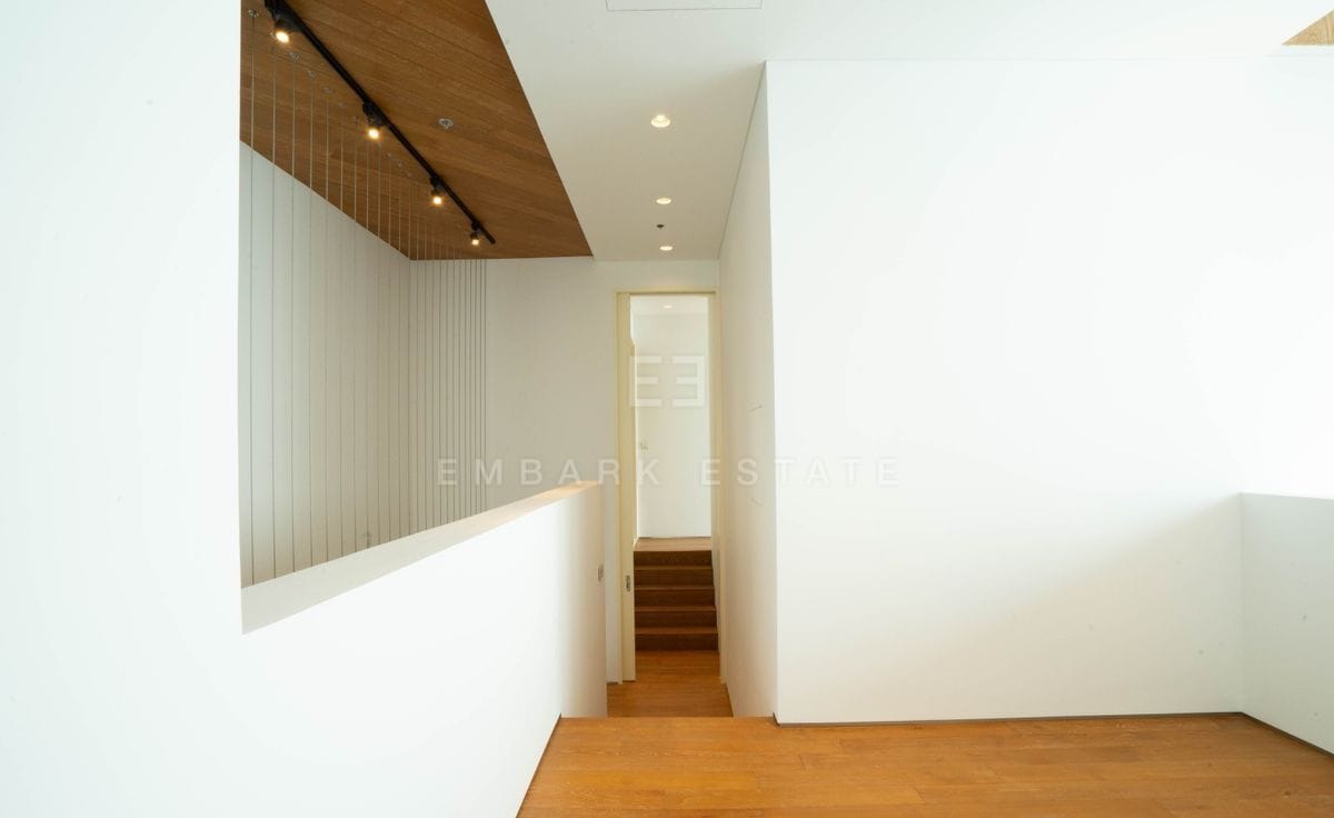 The upper landing of the duplex, a gallery rail over the living space below