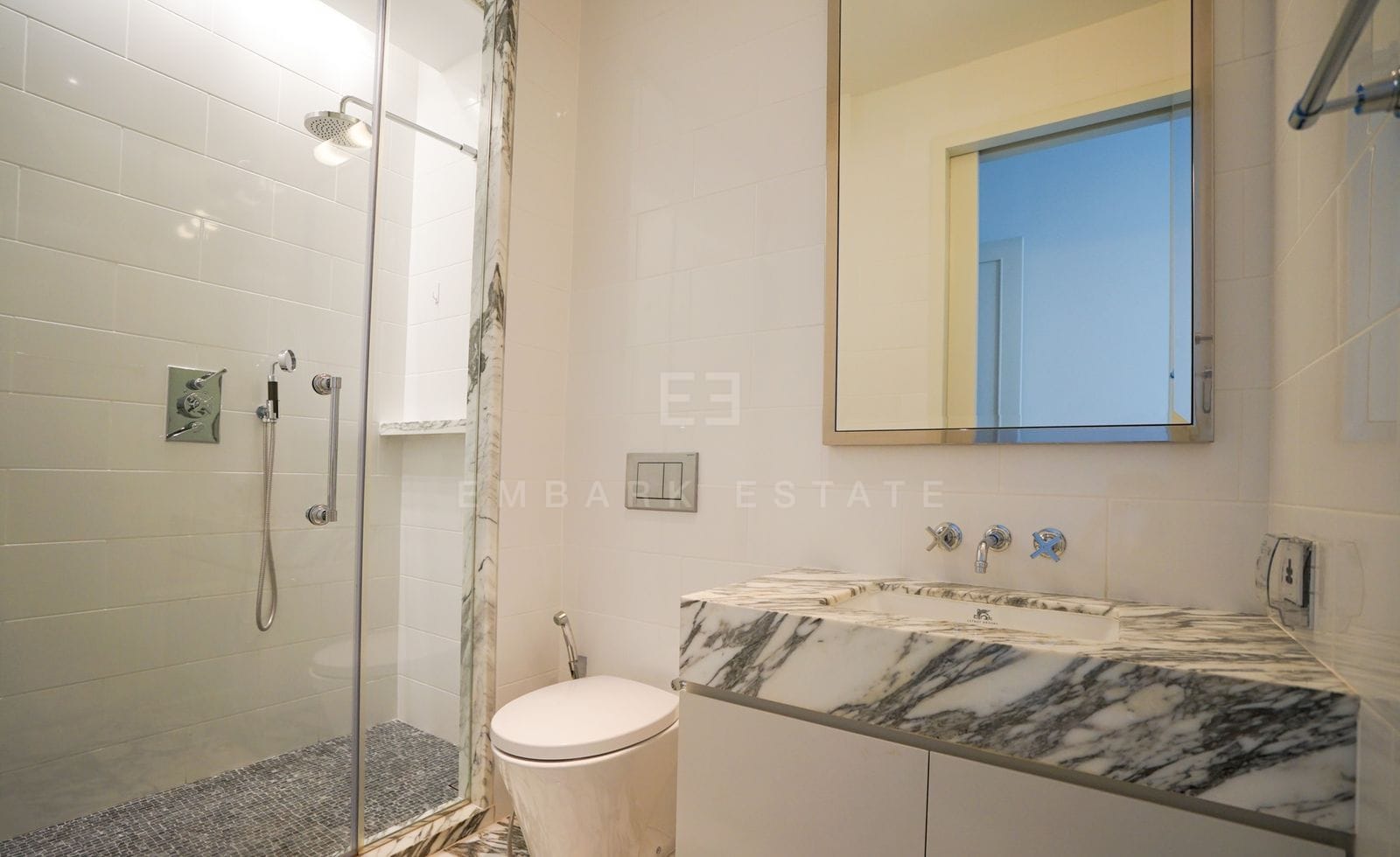 A bathroom of the residence, glazed walk-in shower and an Arabescato marble basin