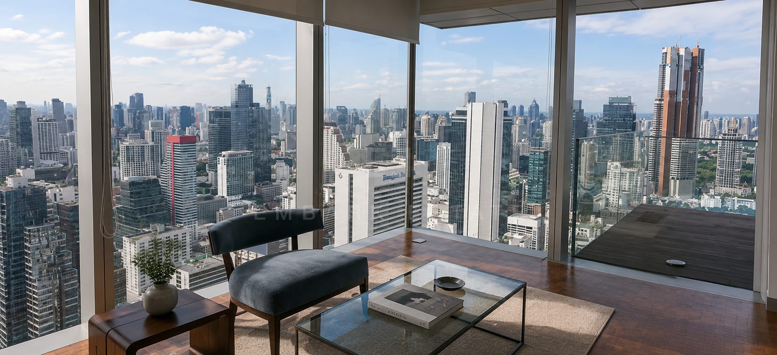 The living room of the 250 square metre residence at The Ritz-Carlton Residences Bangkok, glazing on two sides with the terrace beyond