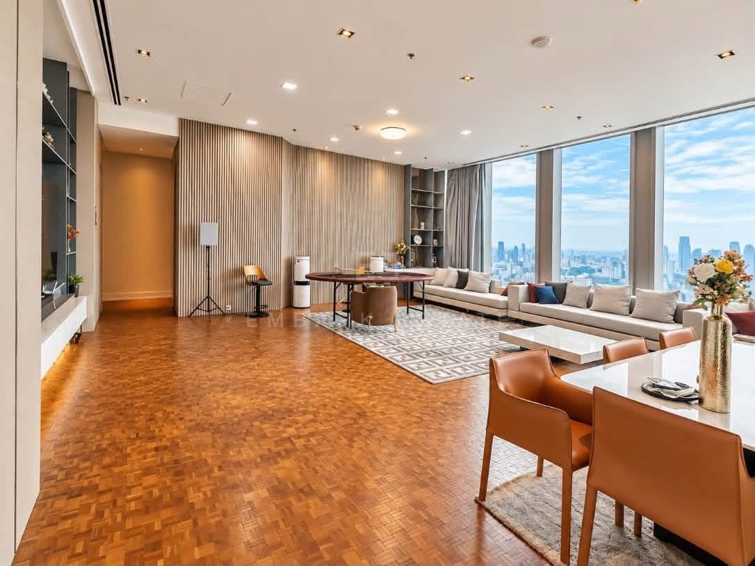 The living and dining room at The Ritz-Carlton Residences Bangkok, a long run of parquet from the entrance to the sofa, with glazing on two sides