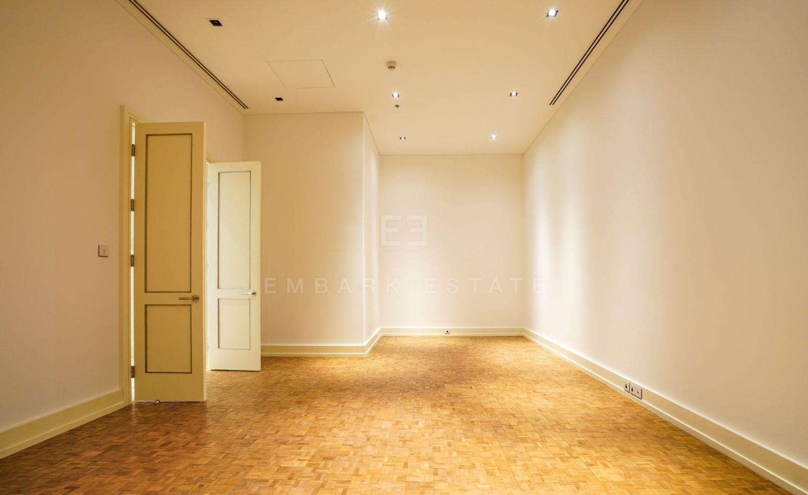 An empty bedroom of the 353 sq.m residence at The Ritz-Carlton Residences Bangkok, wood-block parquet underfoot