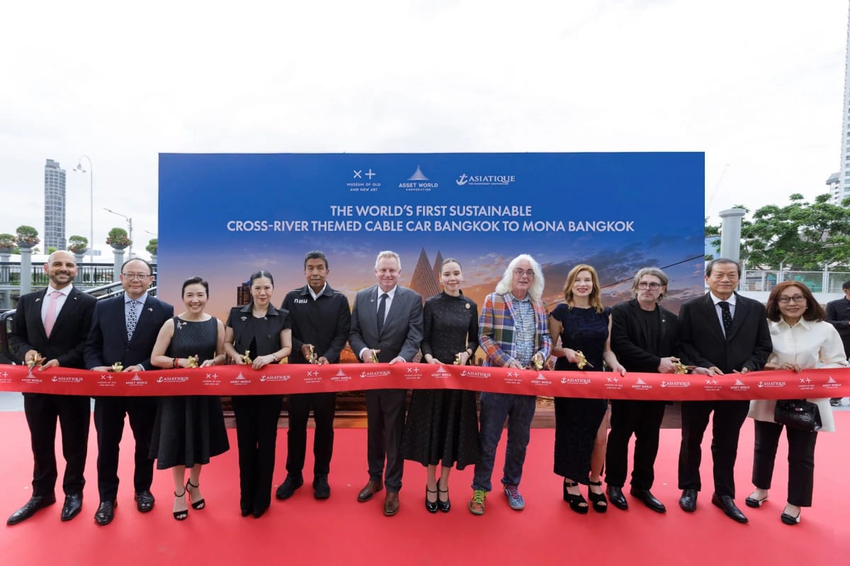 Executives from AWC, MONA and Asiatique cutting a red ribbon at the launch of the cross-river cable car at Asiatique The Riverfront in Bangkok