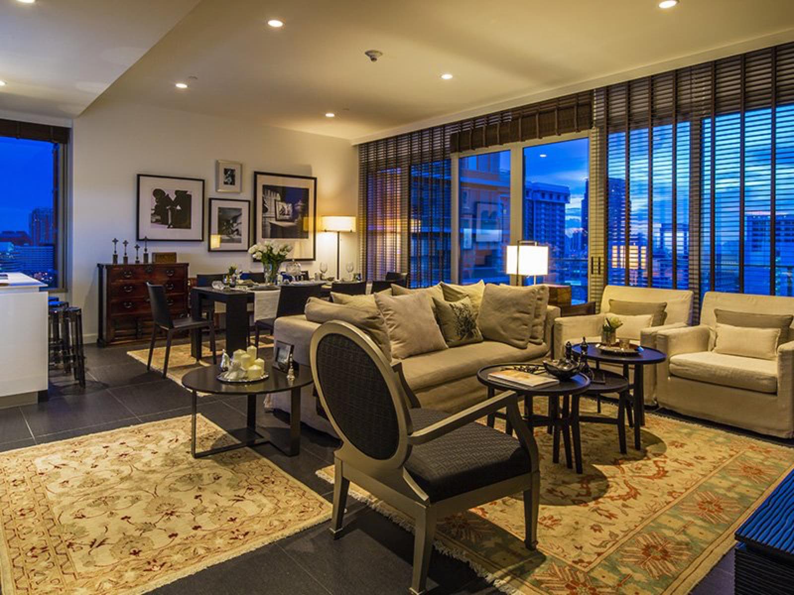 185 Rajadamri: residence living and dining room at dusk with city view